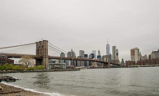 Brooklyn, New York, USA - April 29, 2016: View of Brooklyn Bridge and Manhattan skyline from Dumbo, Brooklyn. Brooklyn Bridge Park. Landmark Brooklyn Bridge is one of the oldest suspension bridges in the United States.