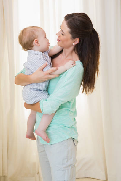 istock Happy mother holding baby boy 692614874