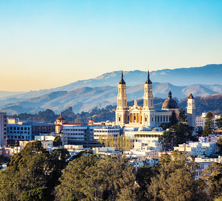 San Francisco St. Ignatius Church en vista elevada del atardecer con colinas photo