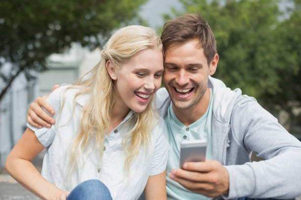 istock Hip young couple looking at smartphone 692622458