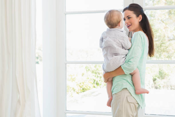 istock Happy mother holding baby boy 692631738