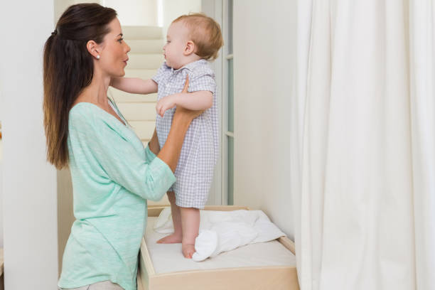 istock Happy mother holding baby boy 692632028