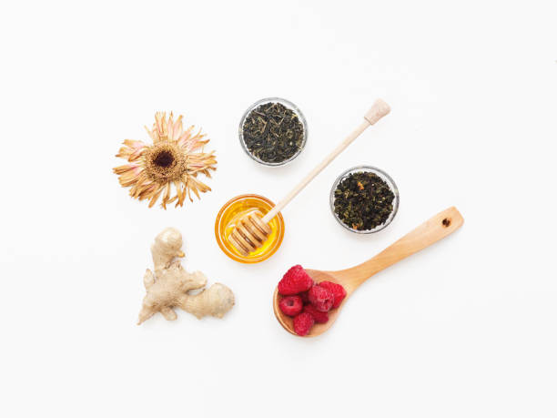 Herbal tea with honey, wild berry and flowers on white background. Flat lay, copy space