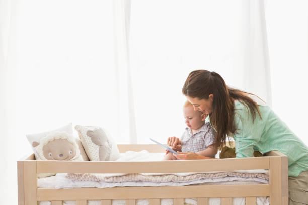 istock Happy mother using tablet with his baby boy 692635272