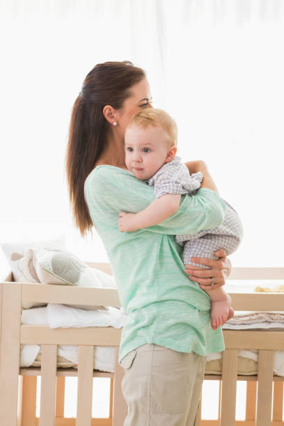 istock Happy mother holding baby boy 692640680