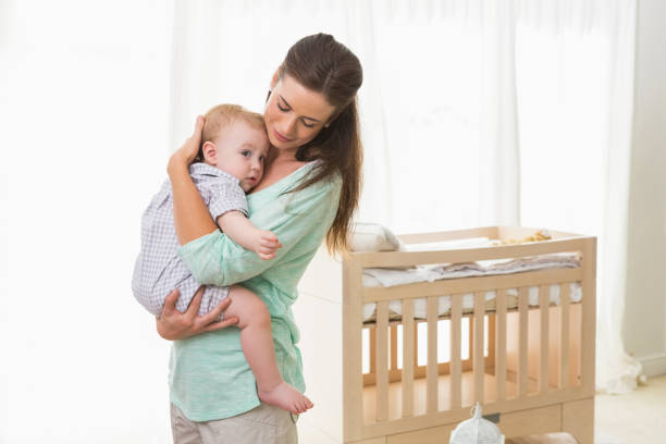 istock Happy mother holding baby boy 692640810