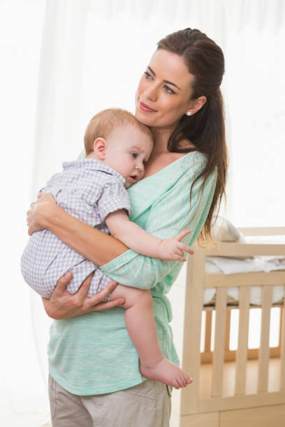 istock Happy mother holding baby boy 692640848
