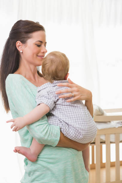 istock Happy mother holding baby boy 692640890
