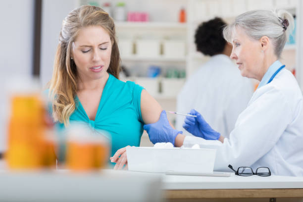 istock Woman makes a face while receiving flu shot 692641822