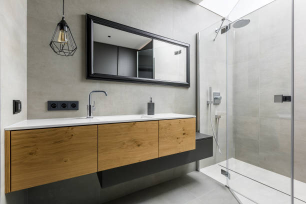 Modern bathroom with shower Modern, gray bathroom with walk in shower, mirror and countertop basin domestic bathroom stock pictures, royalty-free photos & images