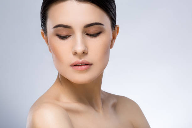 istock Darkhaired girl with nude make up at studio 692651584