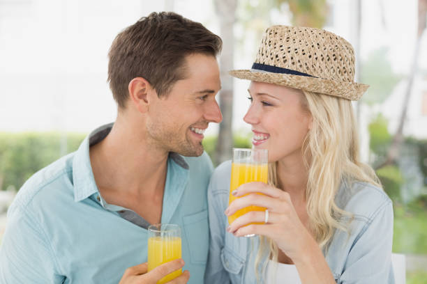 istock Hip young couple drinking orange juice together 692657224
