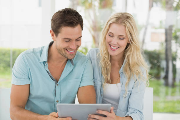 istock Hip young couple looking at tablet together 692657378