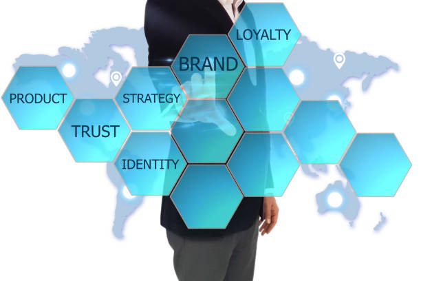 istock Businessman pressing 'BRAND' button on virtual touch screen on blue technology background. Businessman hand pushing blank hexagon shape virtual technology screen 692658052