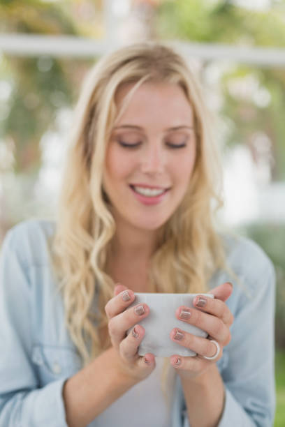 istock Pretty blonde sitting at table having coffee 692661234