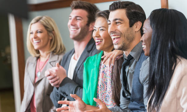 istock Multi-ethnic group of men, women watching presentation 692667176