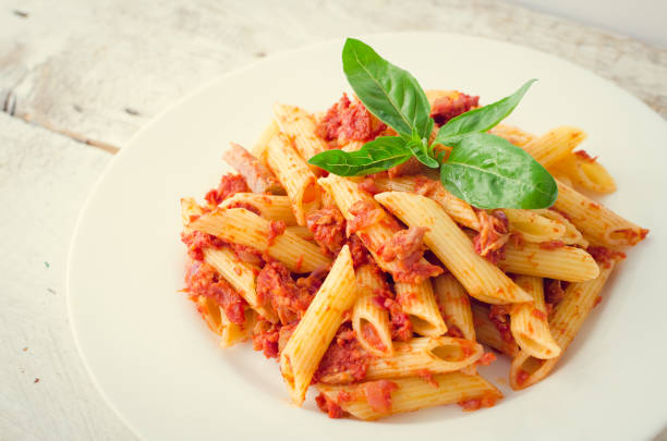 Close up of raw pasta on a blue background.