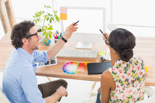 istock Smiling business coworkers pointing screen of computer 692682026