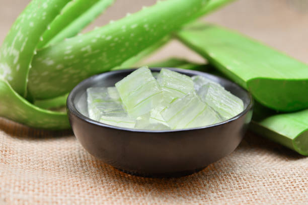 istock aloe vera gel in the black bowl and leaf on rustic fabric background 692684254