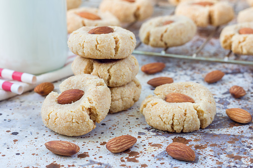 Homemade almond cookies without butter and flour, on table, served with milk, horizontal