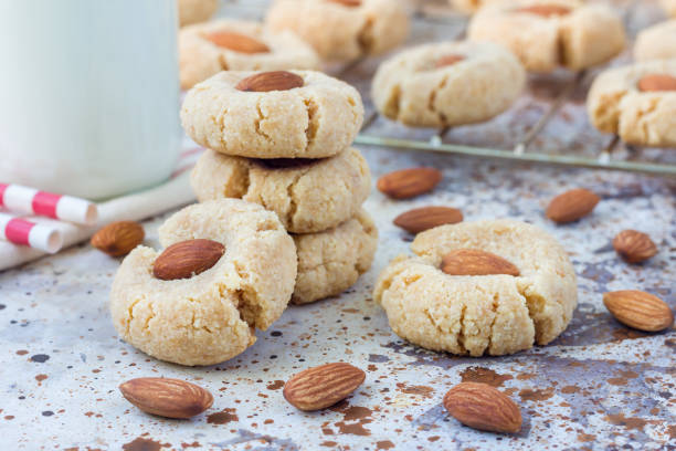 Homemade almond cookies without butter and flour, on table, served with milk, horizontal stock photo