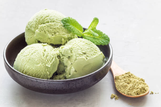 istock Matcha green tea ice cream balls in black bowl, horizontal, copy space 692687300