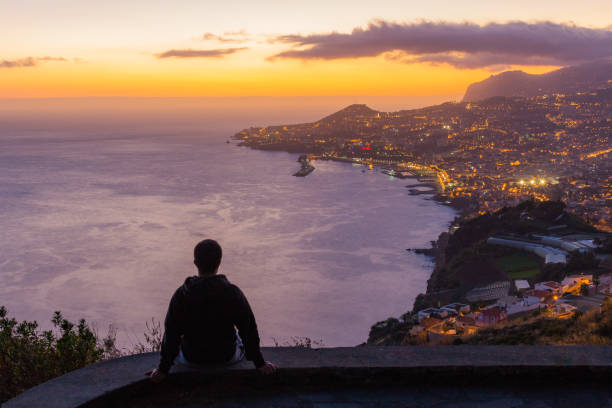 Travel Like a Local - Brief A sunset viewed from Pinaculo viewpoint over Funchal city in Madeira island. funchal stock pictures, royalty-free photos & images