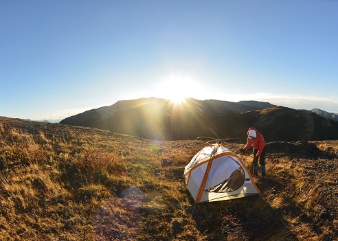 Setting up the tent at sunset on the top of Mount Stearn