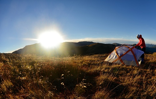 Setting up the tent at sunset on the top of Mount Stearn