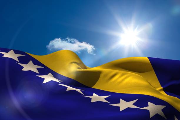 istock Bosnian national flag under sunny sky 692690914