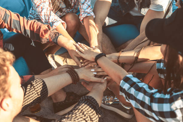 istock group of friends stack of hands together 692693356