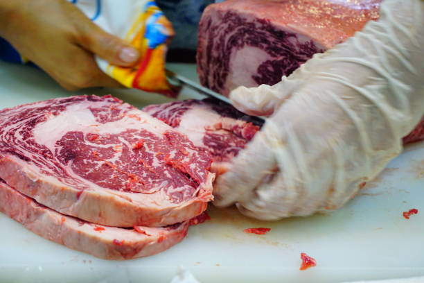 istock Meat being sliced with a knife by hands 692701598