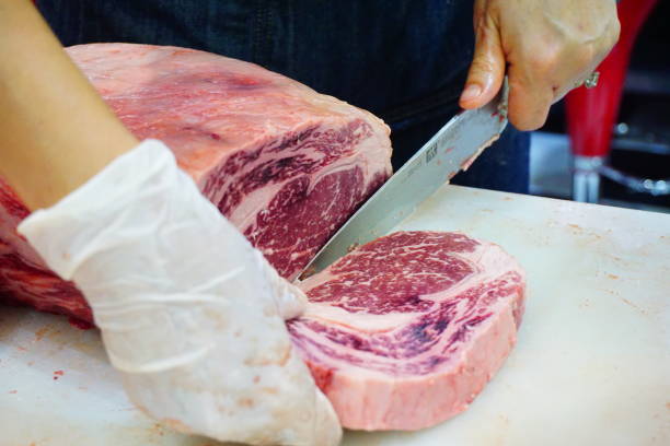 istock Meat being sliced with a knife by hands 692702076