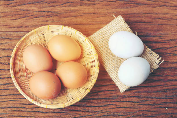 istock Eggs in basket with old beautiful wooden background. 692702602