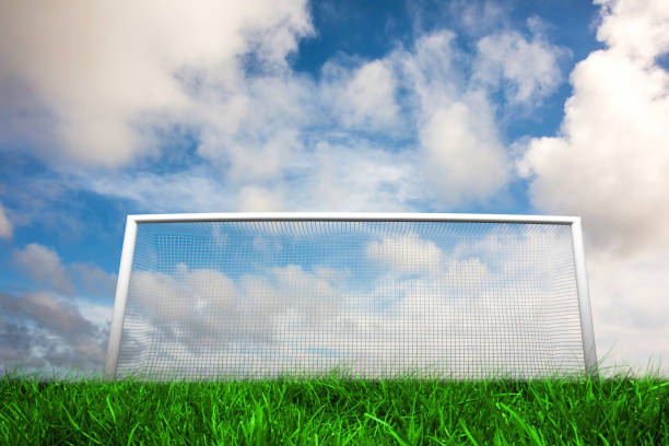 Digitally generated football goal under blue cloudy sky