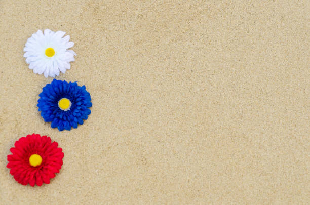 Patriotic USA background with flowers decorations on the sandy beach