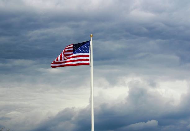 istock American flag on cloudy fay 692710500