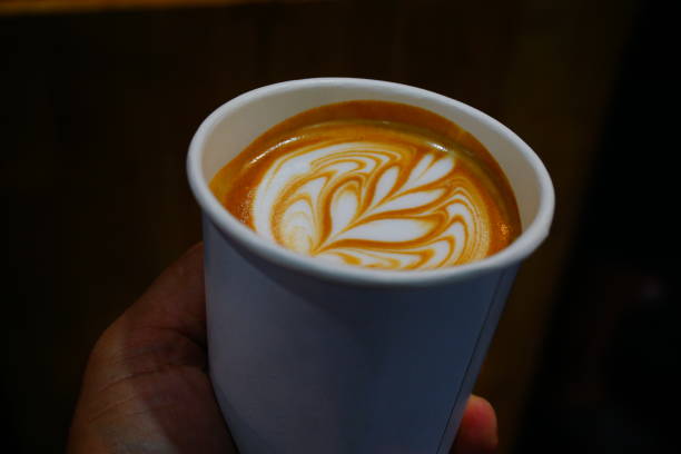 istock Cappuccino with croissant. Two cups of coffee on table 692711556