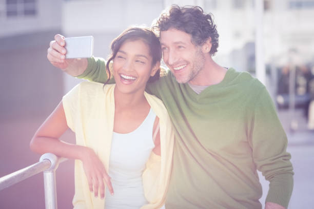 istock couple taking photos of themselves 692714822