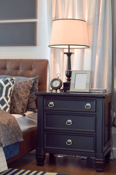 istock Cozy bedroom interior with pillows and reading lamp on bedside table 692718008