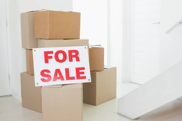 istock For sale sign with many cardboard boxes 692720730