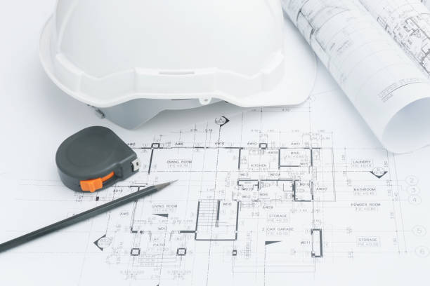 istock Architects workplace - architectural tools, blueprints, helmet, measuring tape, Construction concept. Engineering tools. 692721270
