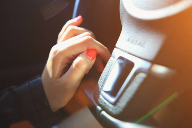 istock Fingers with pink manicure on steering wheel 692724846