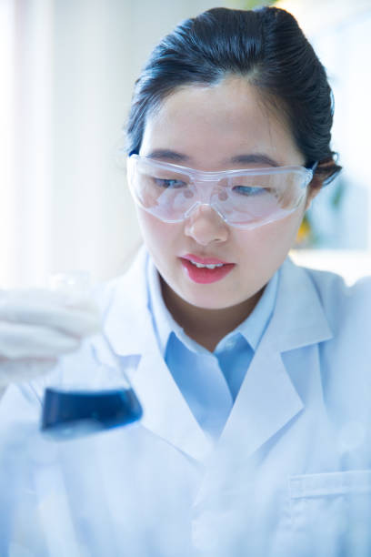 istock female scientist examining test tube 692731300