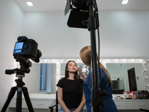 istock Beautician applying cosmetics to blogger 692731592