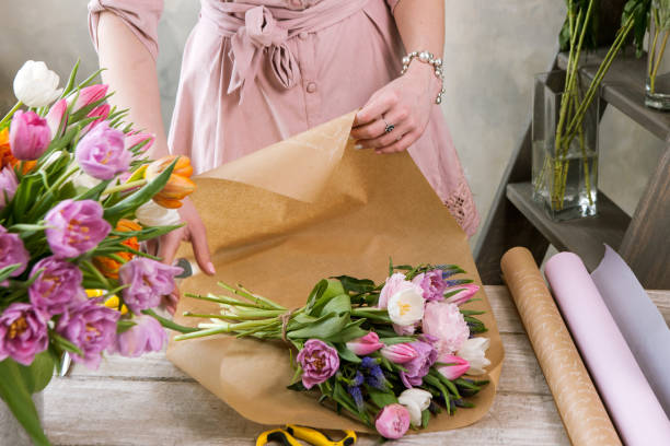 istock Decorator pack festive bouquet in wrapping paper. 692732236