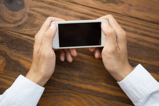 istock Unrecognizable person playing on smartphone 692734626