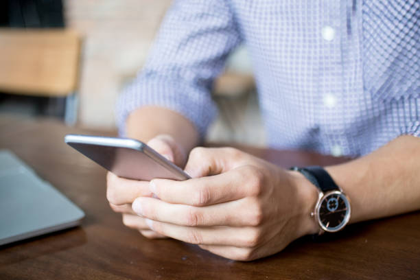 istock Cropped View of Man Texting on Smartphone 692739998