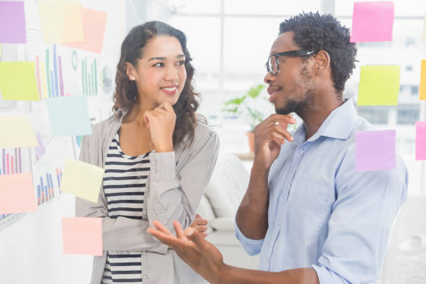 istock Young creative business people talking to each other 692740164