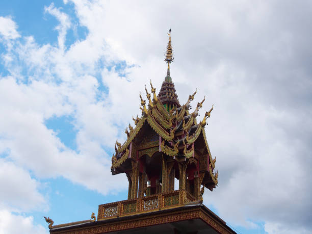 istock Thai style belfry tower in Thai temple with blue sky background 692748196